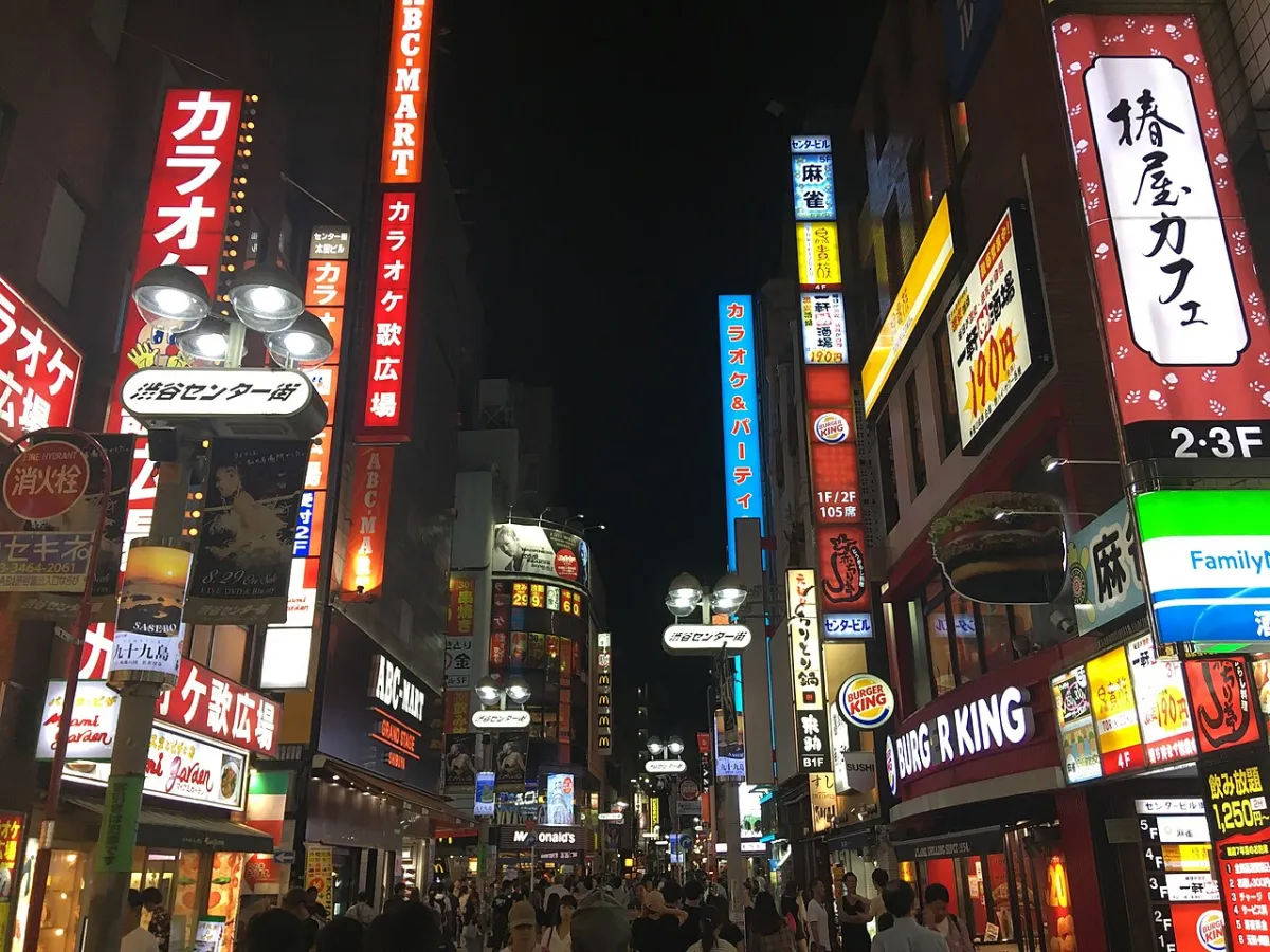 Shibuya Center-gai at night with neon signs and crowds, where late-night ramen is easy to find