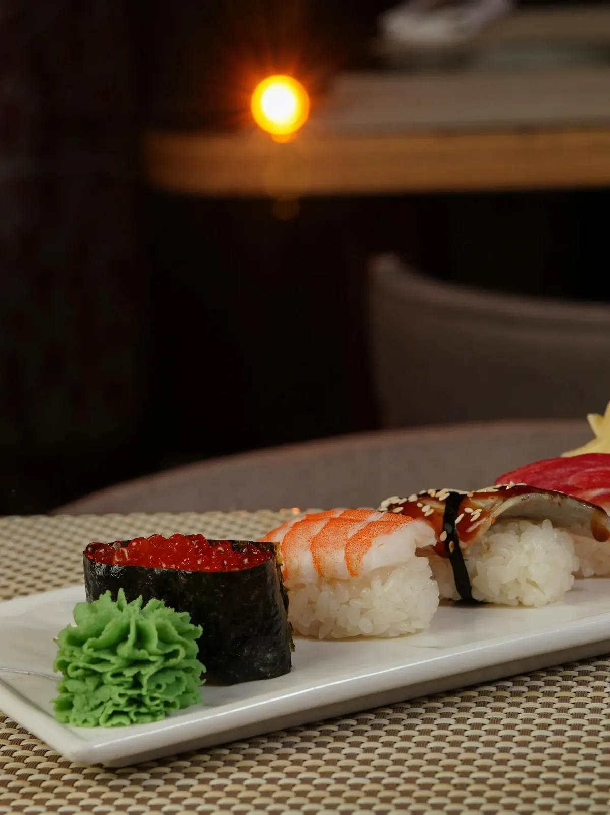 Three high-speed sushi delivery lanes at Uobei with plates zooming toward the table